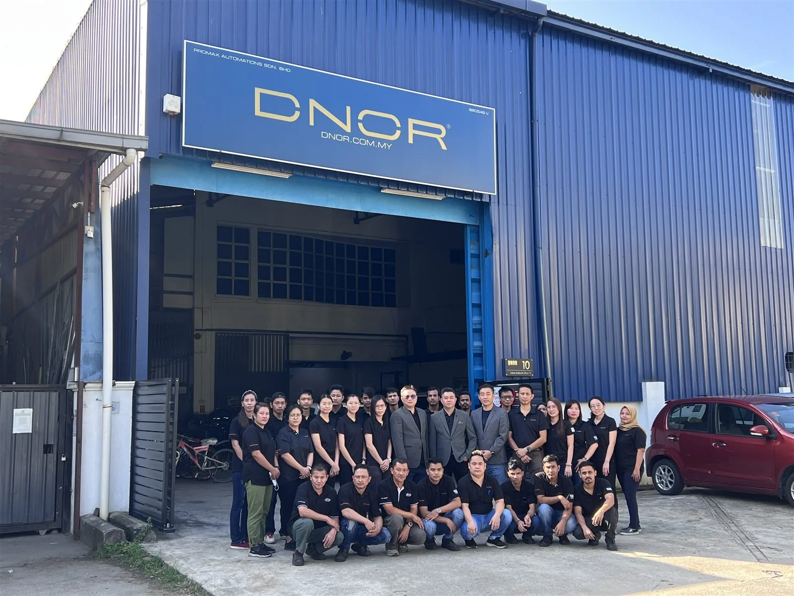 The DNOR team in front of the Puchong factory